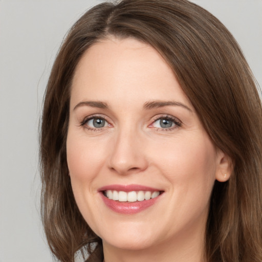 Joyful white young-adult female with medium  brown hair and green eyes