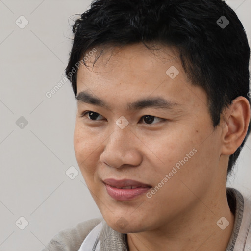 Joyful asian young-adult male with short  black hair and brown eyes