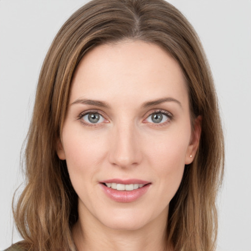 Joyful white young-adult female with long  brown hair and green eyes