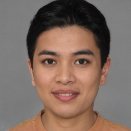 Joyful asian young-adult male with short  brown hair and brown eyes