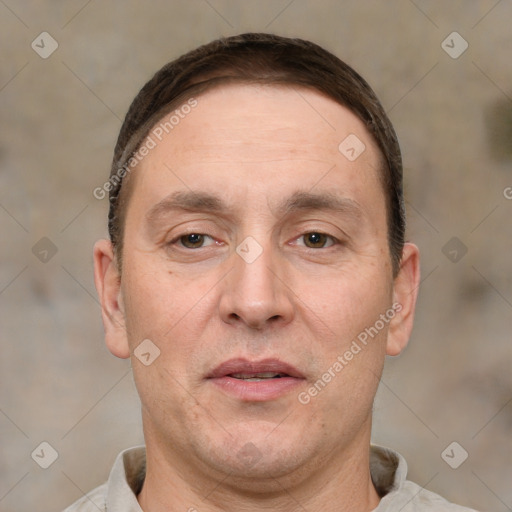 Joyful white adult male with short  brown hair and brown eyes