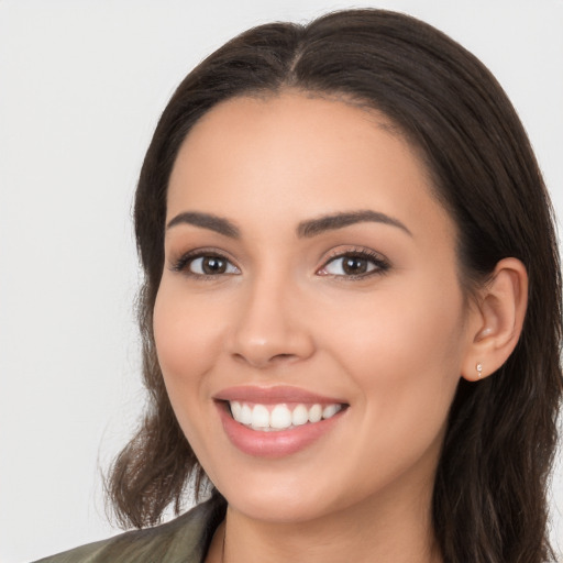 Joyful white young-adult female with long  brown hair and brown eyes