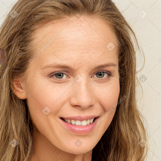 Joyful white young-adult female with long  brown hair and green eyes