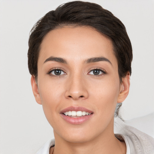 Joyful white young-adult female with short  brown hair and brown eyes