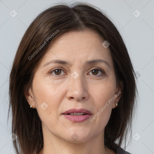 Joyful white adult female with medium  brown hair and brown eyes