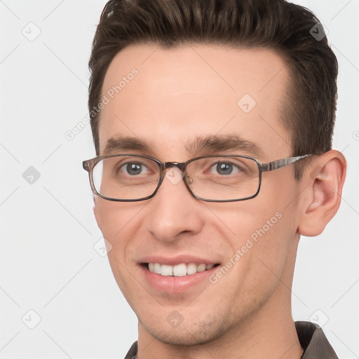 Joyful white young-adult male with short  brown hair and grey eyes