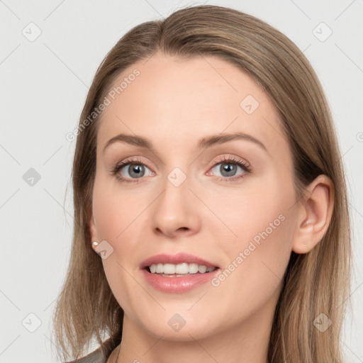 Joyful white young-adult female with long  brown hair and grey eyes