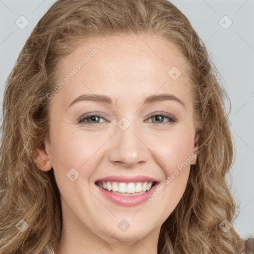 Joyful white young-adult female with long  brown hair and green eyes