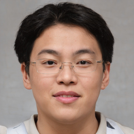 Joyful asian adult male with short  brown hair and brown eyes