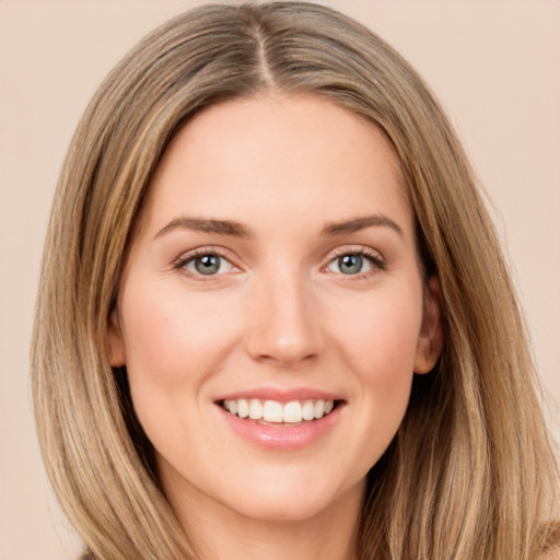 Joyful white young-adult female with long  brown hair and green eyes