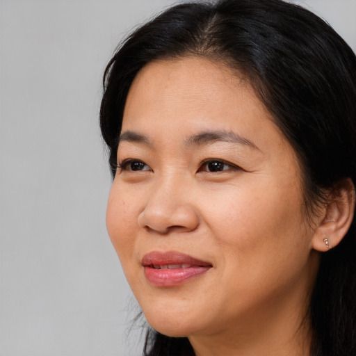 Joyful asian young-adult female with long  black hair and brown eyes