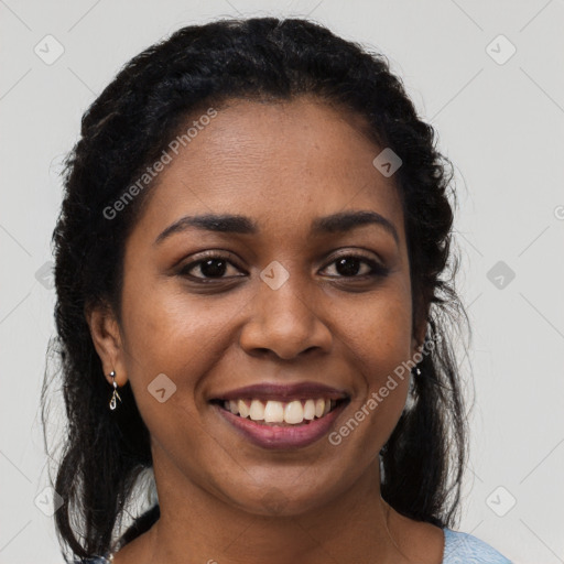 Joyful black young-adult female with long  brown hair and brown eyes