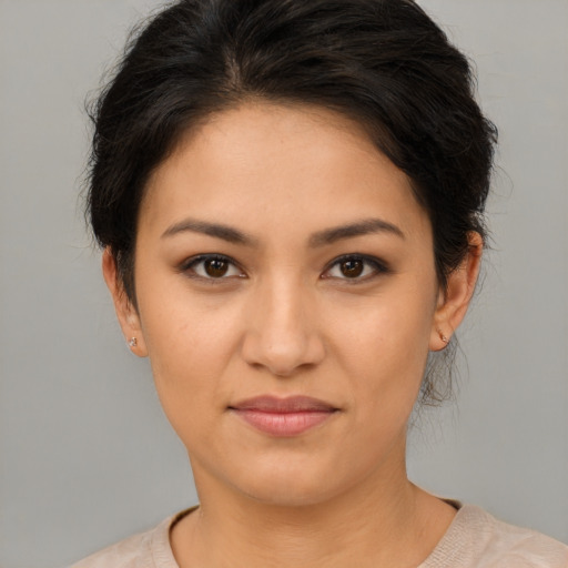Joyful latino young-adult female with short  brown hair and brown eyes
