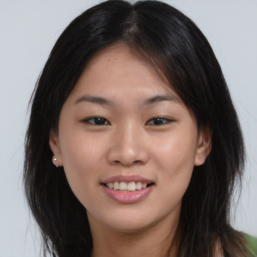 Joyful asian young-adult female with long  brown hair and brown eyes