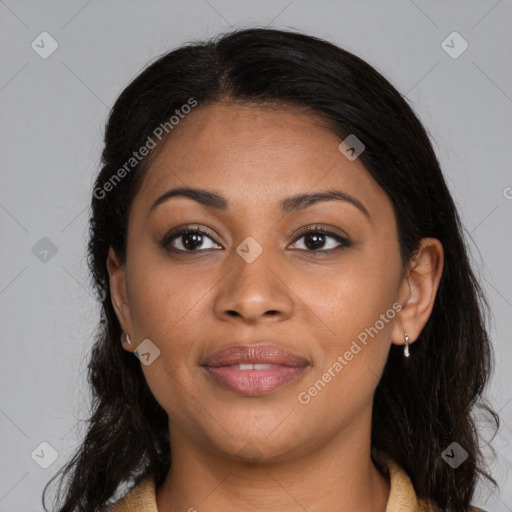 Joyful black young-adult female with long  brown hair and brown eyes