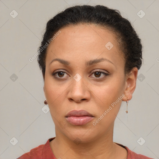 Joyful black adult female with short  brown hair and brown eyes