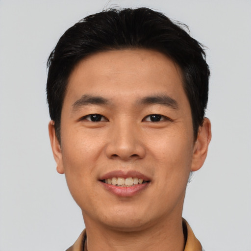 Joyful asian young-adult male with short  black hair and brown eyes