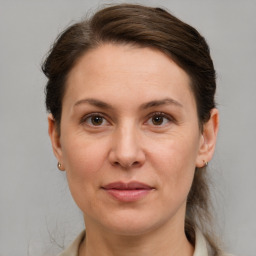 Joyful white adult female with short  brown hair and grey eyes