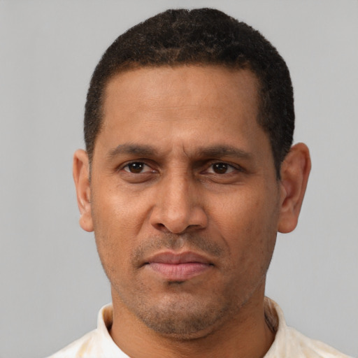 Neutral latino adult male with short  black hair and brown eyes