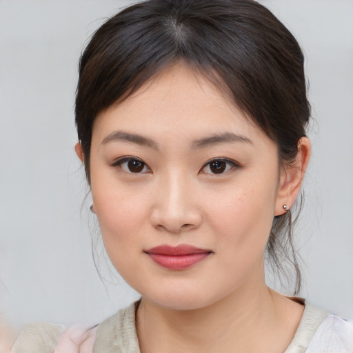Joyful asian young-adult female with medium  brown hair and brown eyes