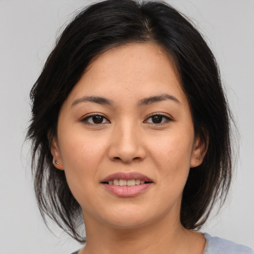 Joyful asian young-adult female with medium  brown hair and brown eyes