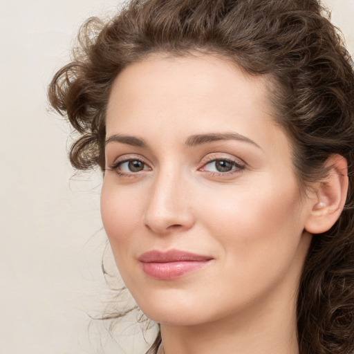 Joyful white young-adult female with medium  brown hair and green eyes