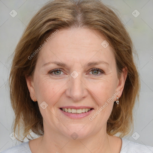 Joyful white adult female with medium  brown hair and blue eyes