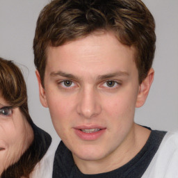 Joyful white young-adult male with medium  brown hair and brown eyes