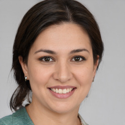 Joyful white young-adult female with medium  brown hair and brown eyes