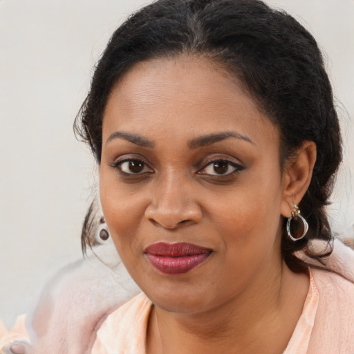Joyful black young-adult female with medium  brown hair and brown eyes
