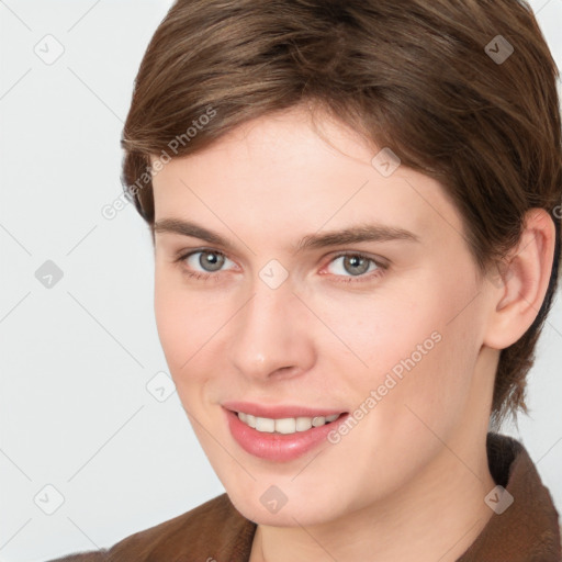 Joyful white young-adult female with short  brown hair and grey eyes