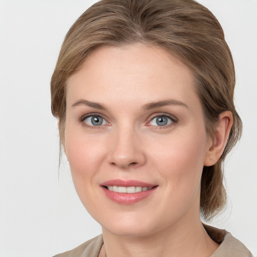 Joyful white young-adult female with medium  brown hair and blue eyes