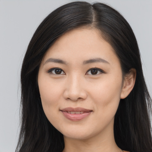 Joyful asian young-adult female with long  brown hair and brown eyes