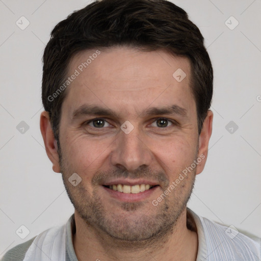 Joyful white adult male with short  brown hair and brown eyes