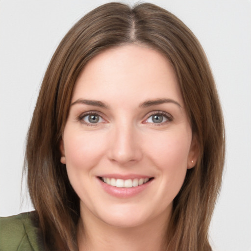 Joyful white young-adult female with long  brown hair and grey eyes