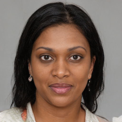 Joyful black young-adult female with medium  brown hair and brown eyes
