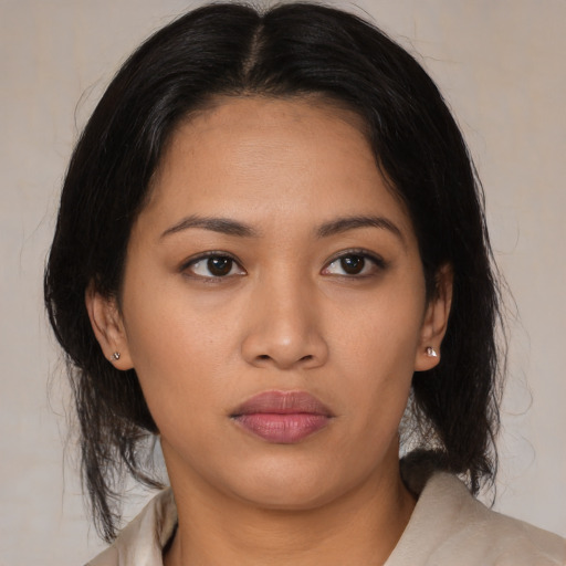 Neutral latino young-adult female with medium  brown hair and brown eyes
