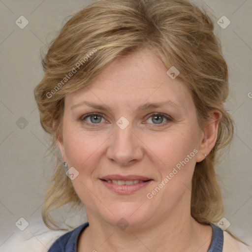 Joyful white adult female with medium  brown hair and blue eyes