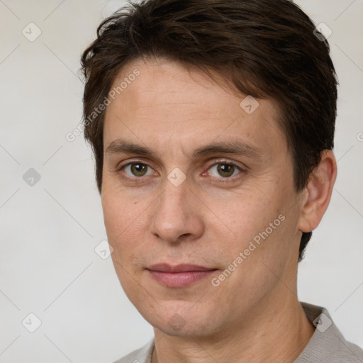 Joyful white adult male with short  brown hair and brown eyes