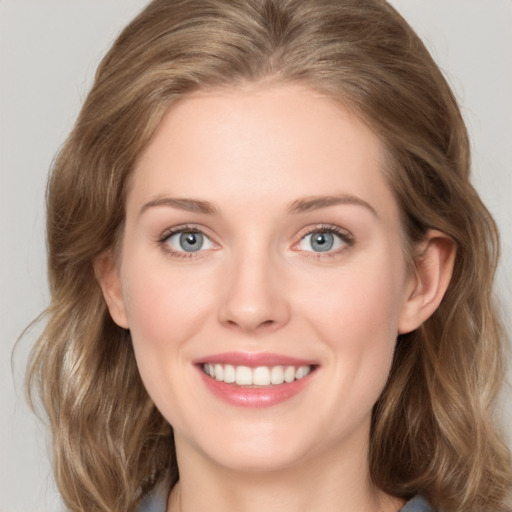 Joyful white young-adult female with medium  brown hair and green eyes