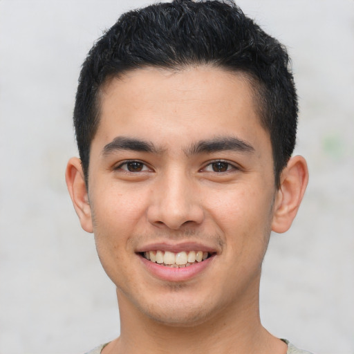 Joyful asian young-adult male with short  brown hair and brown eyes