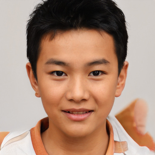 Joyful asian child male with short  brown hair and brown eyes