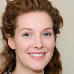 Joyful white young-adult female with medium  brown hair and blue eyes