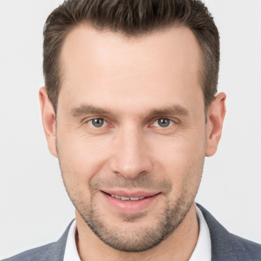 Joyful white young-adult male with short  brown hair and brown eyes