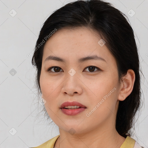 Joyful asian young-adult female with medium  brown hair and brown eyes