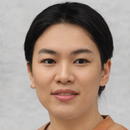 Joyful asian young-adult female with short  black hair and brown eyes