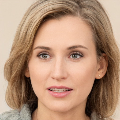 Joyful white young-adult female with medium  brown hair and green eyes