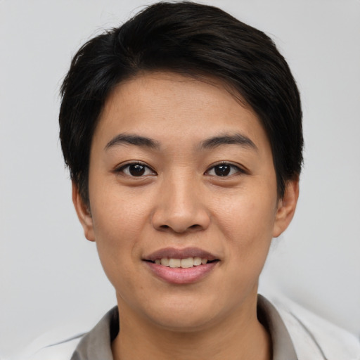 Joyful asian young-adult female with short  black hair and brown eyes