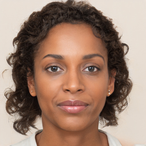 Joyful black young-adult female with medium  brown hair and brown eyes