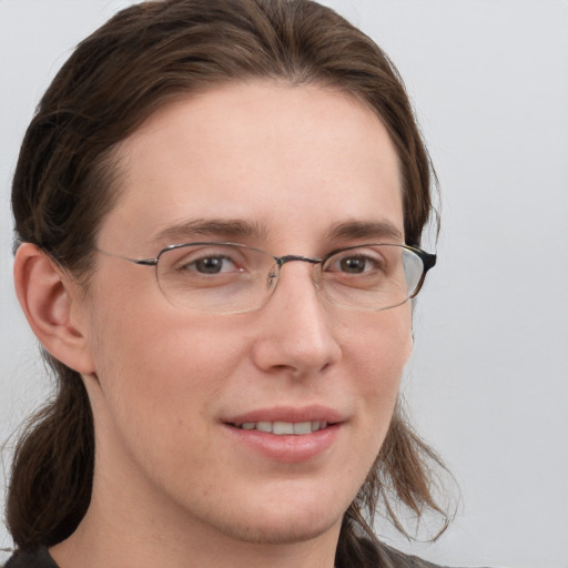 Joyful white adult female with long  brown hair and grey eyes